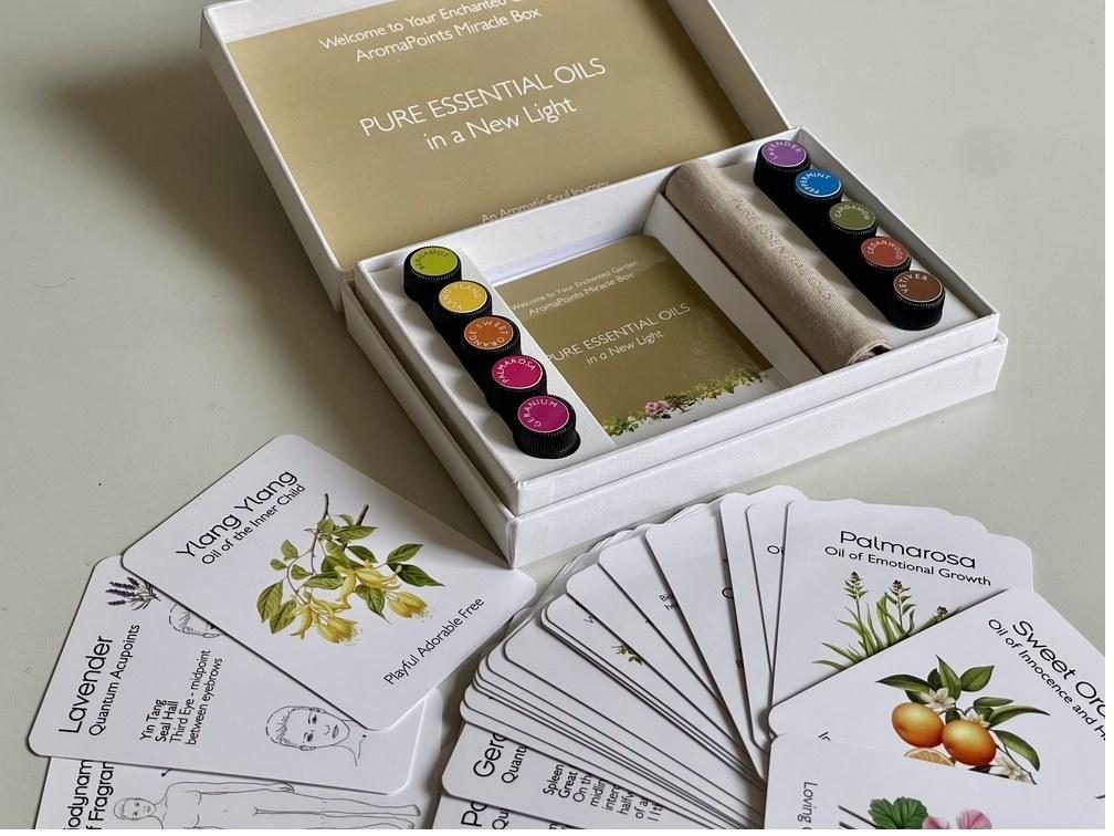 The open box — ten pure essential oils, illustrated cards and a linen roll